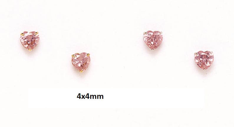 May include: A pair of heart-shaped earrings with pink gemstones. The earrings are 4mm by 4mm.
