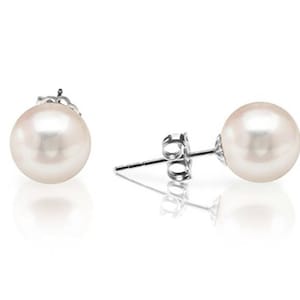 May include: A pair of pearl stud earrings. Each earring features a round, lustrous, off-white pearl set on a silver post with a butterfly backing. The earrings are displayed on a white background with a soft reflection.