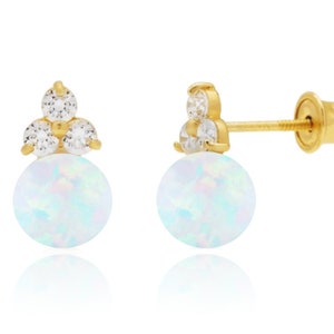 May include: Gold earrings with a white opal stone and three small clear cubic zirconia stones.