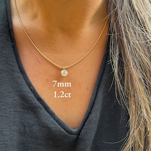 May include: A gold chain necklace with a 7mm, 1.2 carat round diamond pendant.