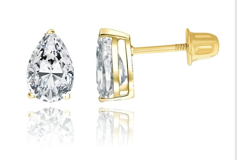 May include: A pair of gold pear-shaped stud earrings with clear cubic zirconia stones.