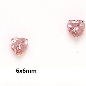 May include: A pair of heart-shaped earrings with pink gemstones, each measuring 6mm by 6mm.