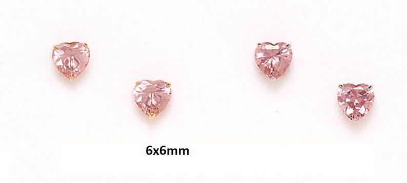 May include: A pair of heart-shaped earrings with pink gemstones, each measuring 6mm by 6mm.