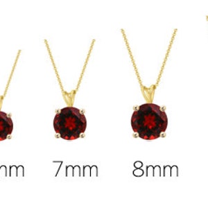 May include: Five round red gemstone pendants on gold chains, ranging in size from 5mm to 9mm.