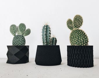 3 small black wooden planters