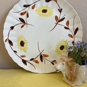 May include: A set of three ceramic mugs with a speckled, matte finish. The mugs are in shades of cream, light gray, and dark gray. Each mug has a simple, minimalist design, perfect for coffee or tea.