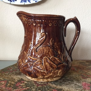 Vintage Rockingham Brown Glazed Pottery Pitcher: Swan & Cattail Motif