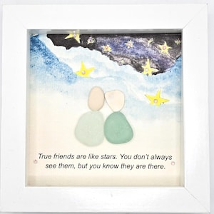 May include: A framed artwork featuring a quote about friendship, "True friends are like stars. You don't always see them, but you know they are there." The artwork is made with sea glass and painted with a starry night sky background.