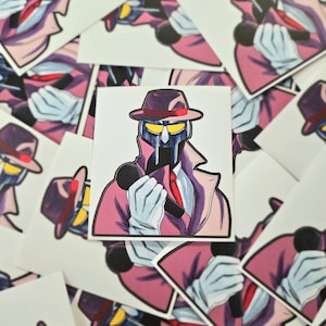May include: Square sticker featuring a masked character in a pink trench coat, fedora, and tie, holding a microphone. The character has a silver mask with yellow eyes and white gloves. The sticker is surrounded by other similar stickers.