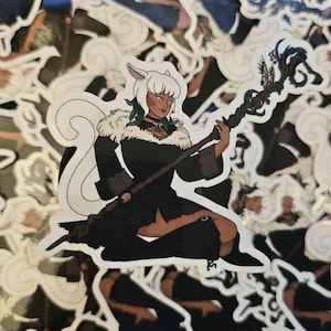 May include: A die-cut sticker featuring an illustrated character with white hair, animal ears, and a long tail. The character wears a black outfit with a white fur collar and holds a dark, twisted wooden staff with ornate, branch-like details.