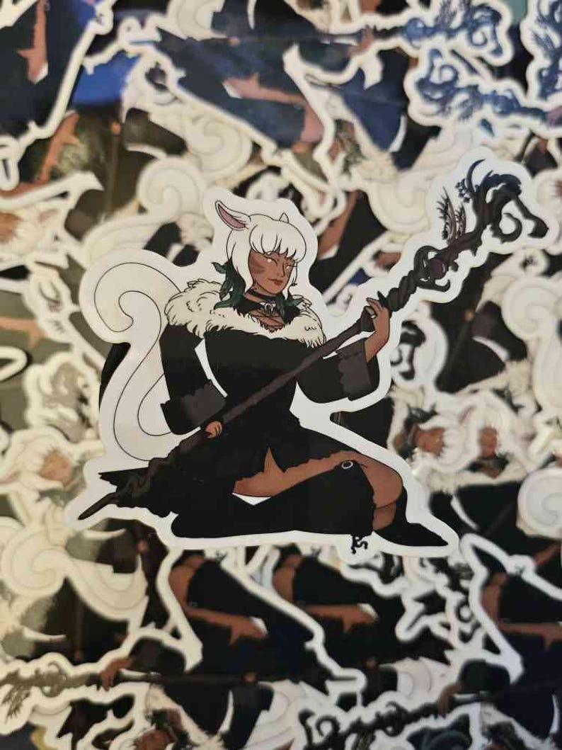May include: A die-cut sticker featuring an illustrated character with white hair, animal ears, and a long tail. The character wears a black outfit with a white fur collar and holds a dark, twisted wooden staff with ornate, branch-like details.