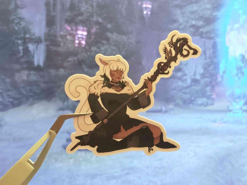May include: A die-cut sticker featuring an illustrated character with light hair and cat-like ears, wearing a dark coat with a fur collar. The character is kneeling and holding a long, dark, twisted wooden staff topped with intricate, organic, branch-like designs.