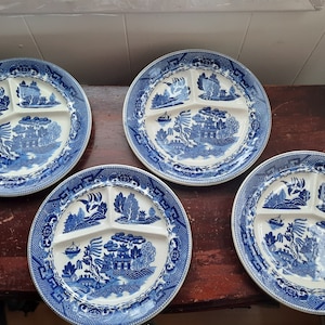 May include: Four blue and white divided plates with a traditional Chinese design. The plates are made of ceramic and have a glossy finish.