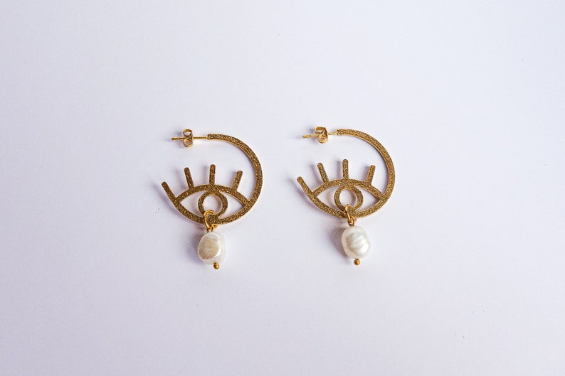 graphic Paloma evil eye style modern 24k gold plated earrings with freshwater pearl drops