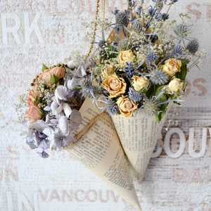 Arrangement in a vintage cone of dried flowers with thistle, lavender, roses, hydrangea