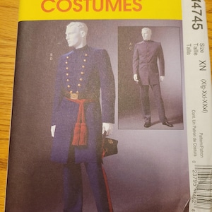 May include: McCall's Costumes sewing pattern M4745. The pattern features a navy blue military-style costume with gold buttons, a red sash, and matching pants. The package has a yellow top with the brand name in red.