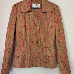 May include: A multi-colored patterned blazer with a button closure and a label that reads "Chrysoula" in white text.