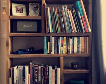 Bücherregal mit eingearbeiteten Staufächern.