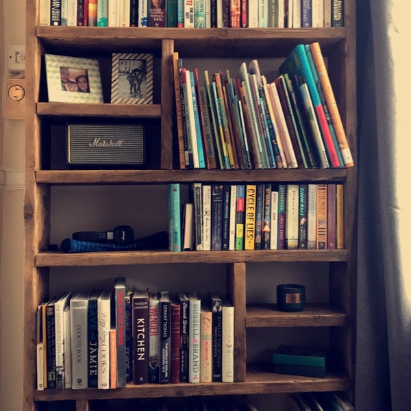 Bookcase with purpose built storage compartments.