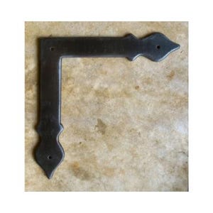 May include: Black metal corner brace with a decorative, pointed design. The brace has two holes for attaching to a surface.