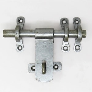 May include: Silver metal door bolt with two sets of mounting brackets. The bolt has a sliding latch and a round handle.