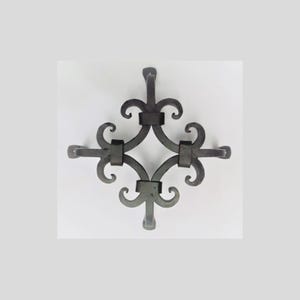 May include: A dark gray, wrought iron decorative element with a symmetrical design. The piece features a central diamond shape with curved flourishes and horizontal extensions. It is likely used for architectural or decorative purposes.
