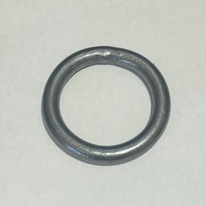 May include: A silver metal ring, approximately 1 inch in diameter.