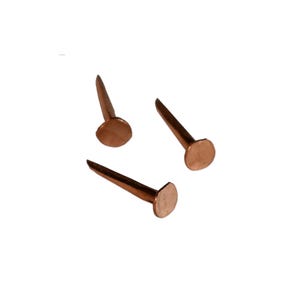 May include: Three copper tacks with round heads. The tacks are arranged in a triangular pattern.