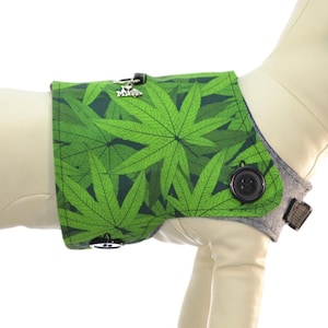 May include: A green and black dog harness with a leafy pattern. The harness is shown on a white mannequin. A size chart is included with neck, chest, and weight measurements in inches and pounds.