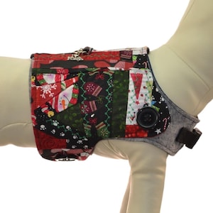 May include: A red, green, and black dog harness with a Christmas-themed pattern. The harness is on a white mannequin. A size chart is included with neck, chest, and weight measurements in inches and pounds.