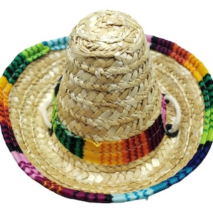 May include: A small straw sombrero with a colorful woven band. The band features a variety of colors, including pink, blue, green, yellow, orange, and red.