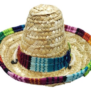 May include: A small straw sombrero with a colorful woven band. The hat is made of natural straw and has a wide brim.