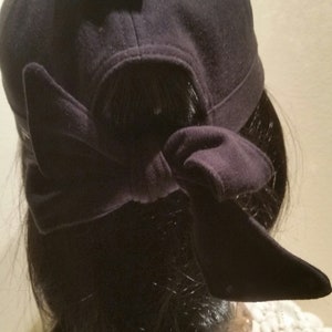 May include: Black baseball cap with a Fila Sport logo and a black fabric tie at the back.
