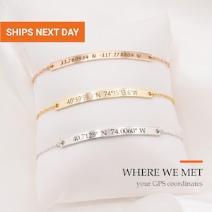 May include: Three delicate chain bracelets with curved metal bars, each engraved with unique GPS coordinates. The top bar is rose gold, the middle is yellow gold, and the bottom is silver. The text WHERE WE MET your GPS coordinates is visible.