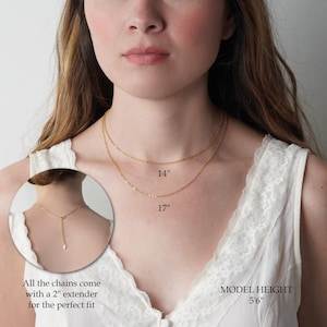 a close-up of a woman's neck and chest area, with a focus on the necklaces she is wearing. The necklaces are described as 14" and 17" in inches, and the image also includes a close-up of the necklace's clasp.