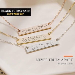 May include: Three horizontal bar necklaces in rose gold, gold, and silver tones. Each metal bar features engraved outlines of United States states separated by small heart symbols. The text NEVER TRULY APART all your states is visible.