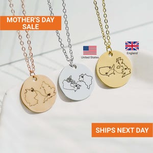 May include: Three necklaces with round pendants, each featuring a map design. One is gold-toned with a map of Europe, another is silver-toned with a map of North America, and the third is gold-toned with a map of the United Kingdom and the United States. The text "MOTHER'S DAY SALE" is visible.