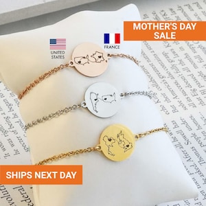 May include: Three delicate bracelets with circular pendants, each featuring a map outline and heart design. The bracelets are in rose gold, silver, and gold tones. The image includes the text "Mother's Day Sale".