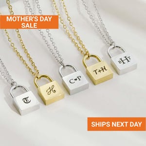 May include: Five personalized padlock necklaces with initials engraved on the lockets. The necklaces have either gold or silver chains and lockets. The text "MOTHER'S DAY SALE" is in the top left corner.