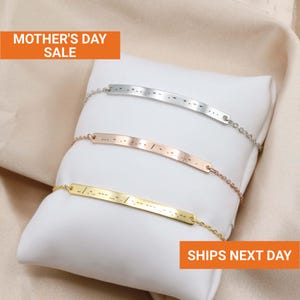 May include: Three metal bar bracelets in silver, rose gold, and gold, each with a Morse code design. The bracelets are displayed on a white pillow with the text "MOTHER'S DAY SALE" and "SHIPS NEXT DAY".