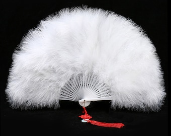 May include: A white feather fan with a white plastic frame and a red tassel. The fan is closed and the feathers are spread out.