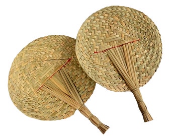 May include: Two woven straw fans with red string accents and a natural brown color.
