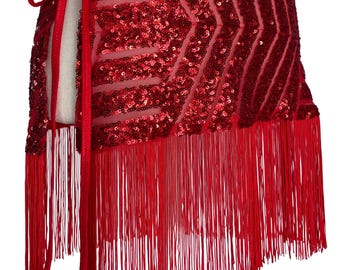May include: A red wrap skirt featuring a sheer mesh base covered in dense, shimmering red sequins arranged in a chevron pattern. The garment includes a long, flowing red fringe hem and a side tie closure with two small red decorative beads.