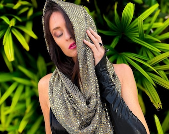 May include: A gold and black sequined cowl neck scarf with a loose fit. The scarf is made of a soft, stretchy material and has a subtle shimmer.