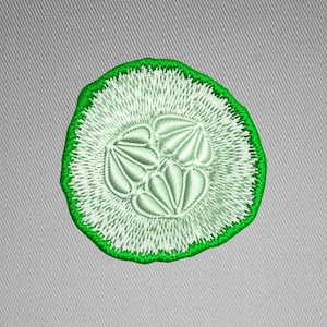 May include: A green and white embroidery design of a cucumber slice. The design is ideal for adding a touch of whimsy to your projects.