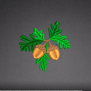 May include: Machine embroidery design of two acorns with green oak leaves. The design is labeled with file formats: .DST, .EXP, .HUS, .JEF, .PCS, .PES, .VIP, .VP3, .XXX.