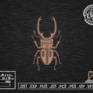 May include: A brown and black stag beetle embroidery design, 1.25 inches by 2.2 inches, with 1602 stitches and 1 color. The design is labeled "TESTED" and "APPROVED" in a white circle with stars.
