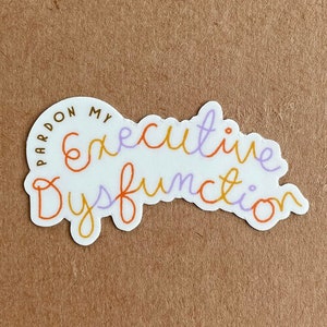 May include: White sticker with the text "Pardon my executive dysfunction" in orange, purple, and brown lettering.