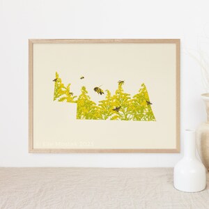 May include: A framed print of a yellow and green silhouette of the state of Connecticut with bees flying around it. The print has the text "Ellie Mostek 2023" in the bottom left corner.