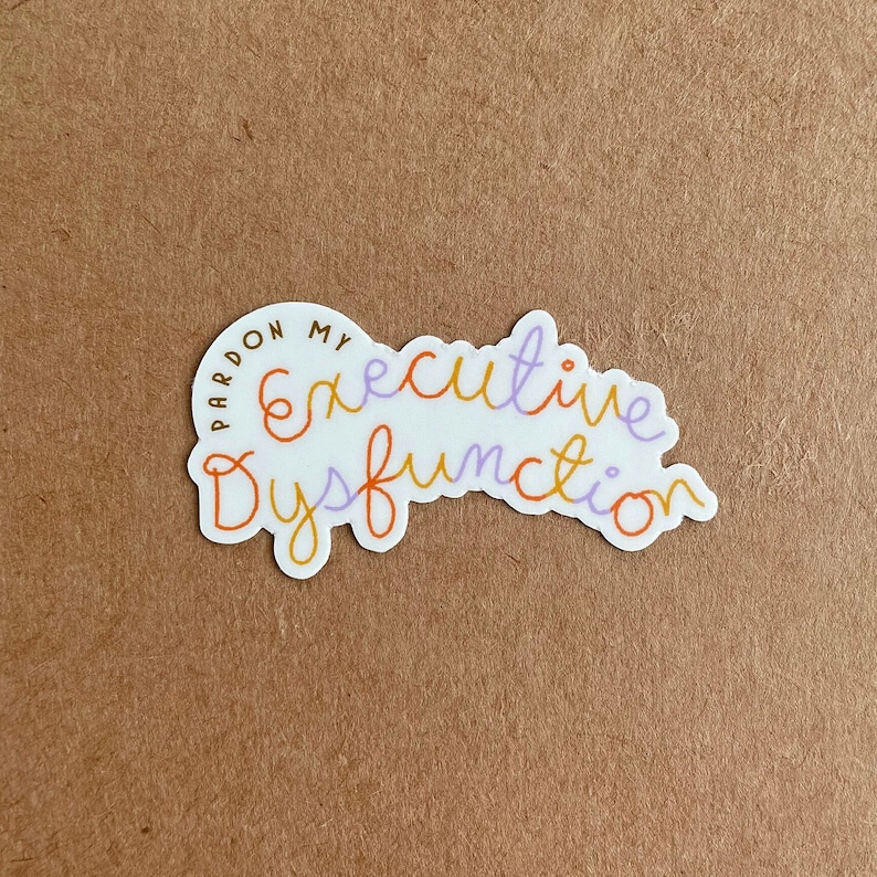 May include: White sticker with the text "Pardon my executive dysfunction" in orange, purple, and brown lettering.